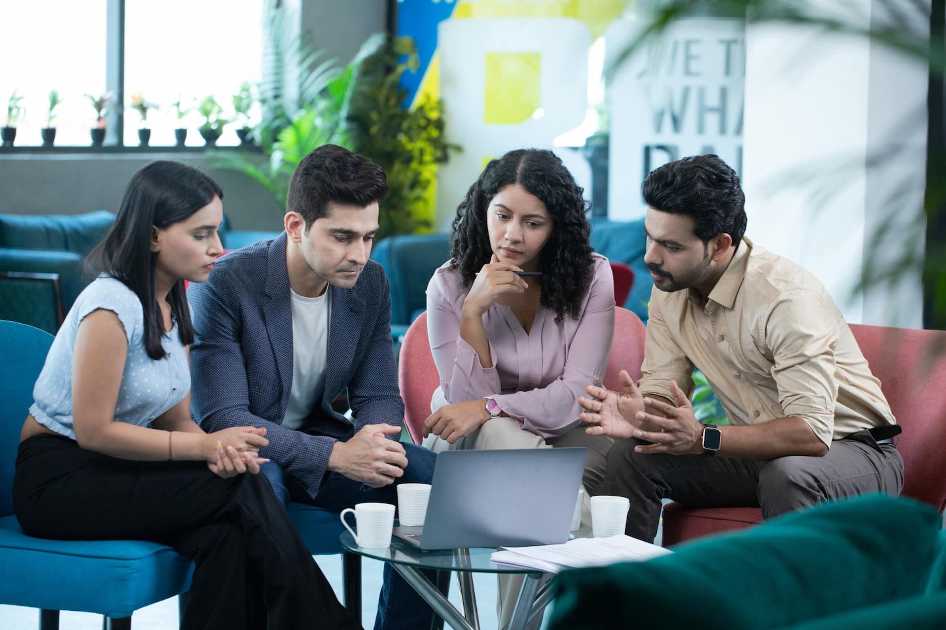 Young digital marketing professionals collaborating in a modern office environment – Careers at Infinitio Digital marketing agency.